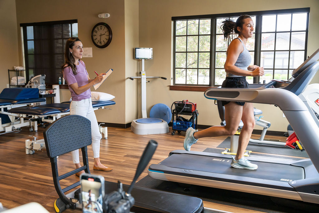 Dr. Leibler observing a runner on a treadmill during a running assessment at Fit & Function in Boise.