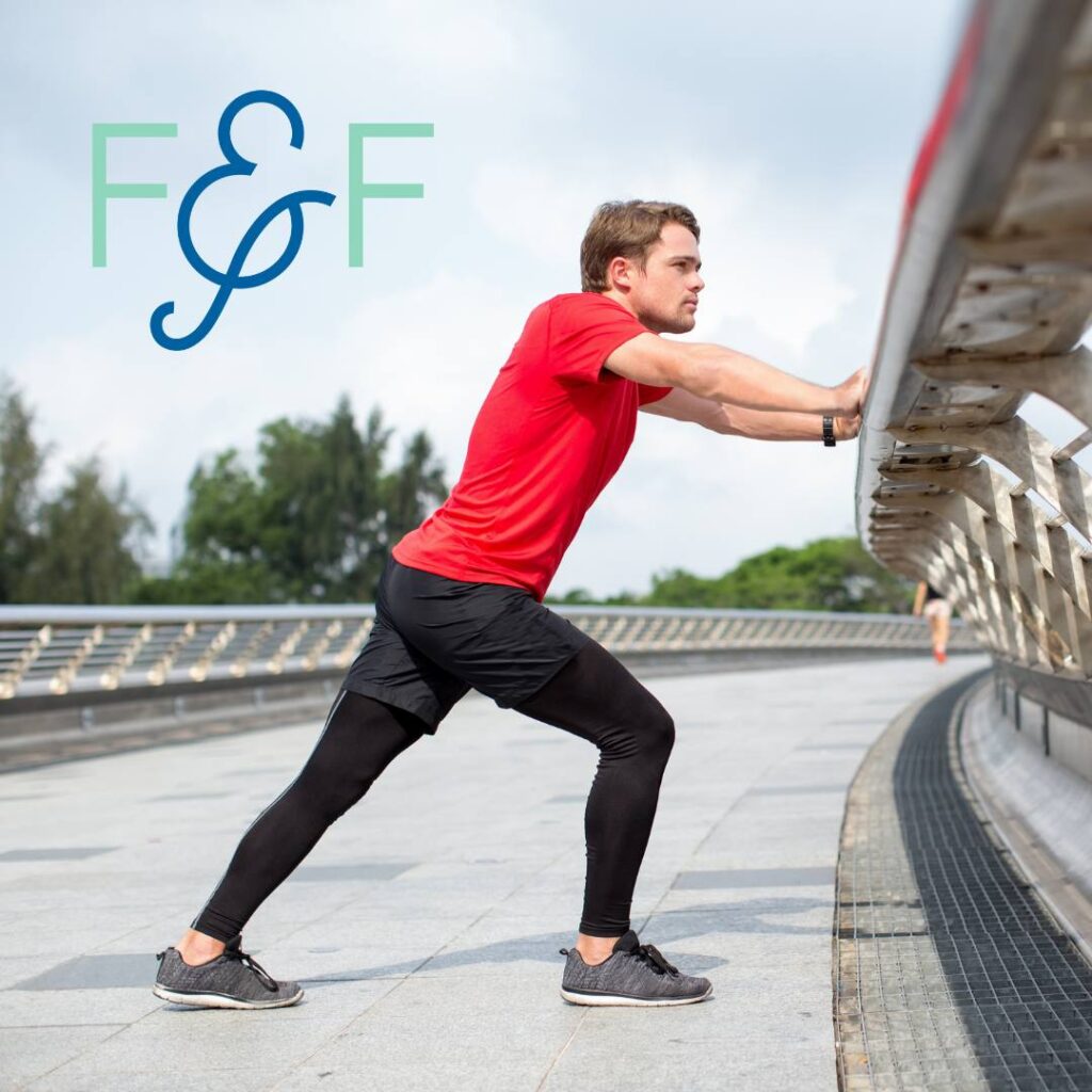 Runner stretching their tight calf outside after a run to prevent calf strain in runners.