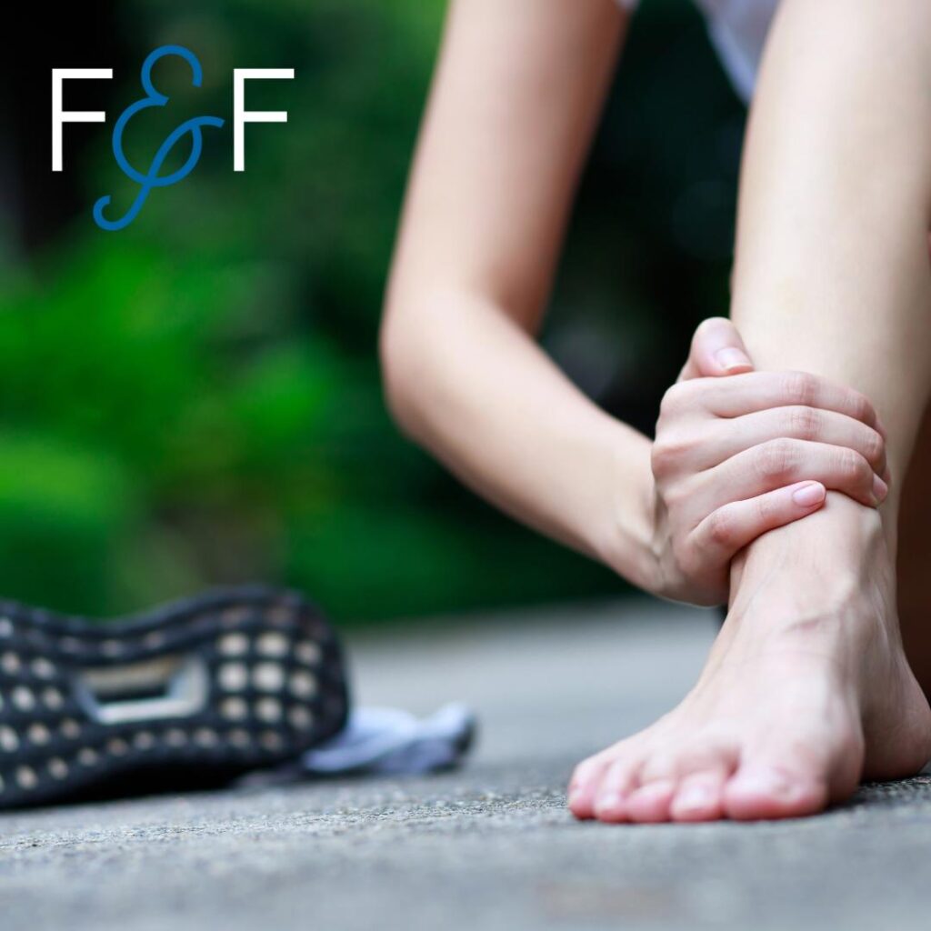 An image showing a runner holding their lower leg, emphasizing the importance of preventing bone stress injuries.
