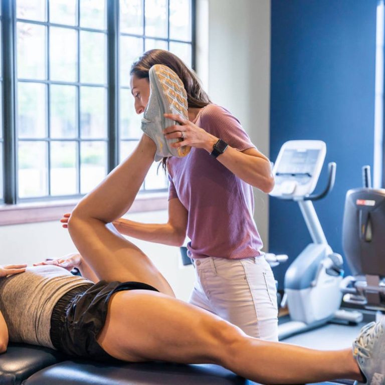 Boise physical therapist performing hip mobility treatment for female patient